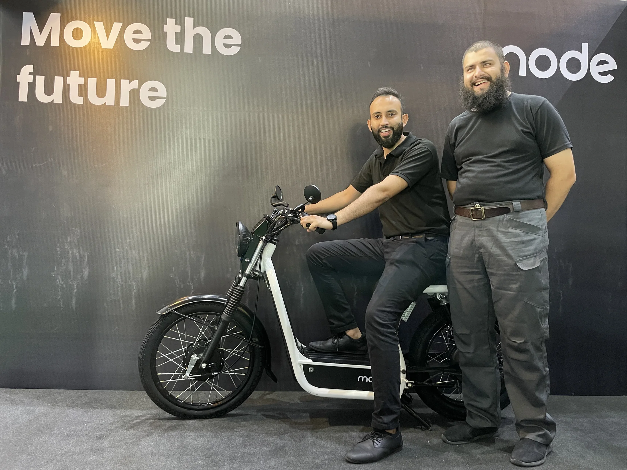 Mode Mobility co-founders beside an electric motorcycle